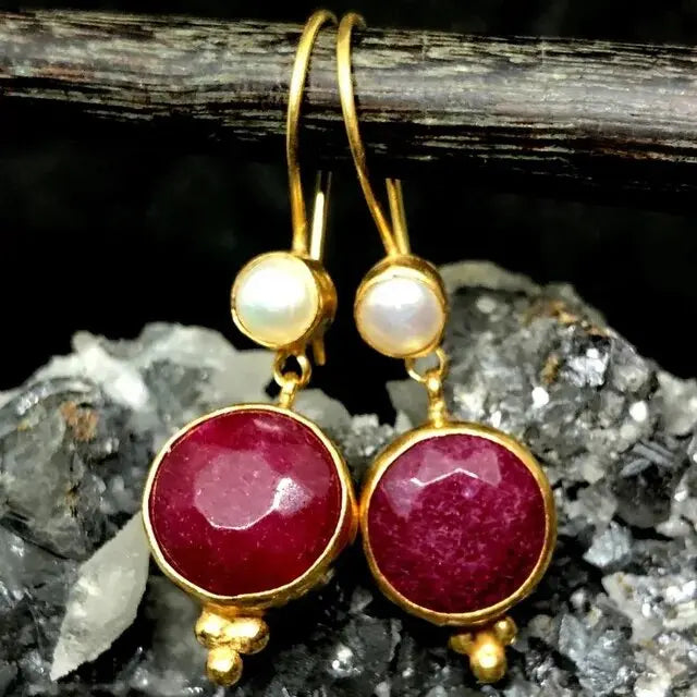 Red earrings and pearls in vintage gold