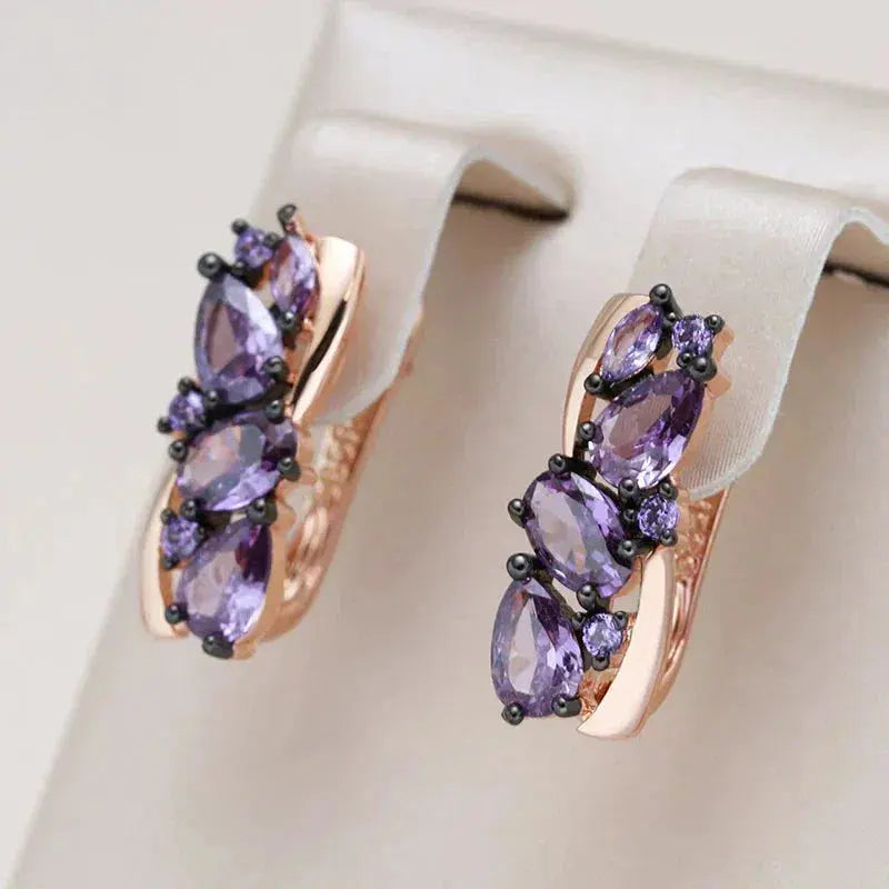 Elegant earrings with small purple crystal in gold