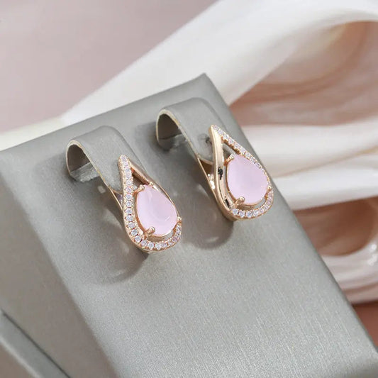 Elegant shiny earrings made of gold and pink cubic zirconia