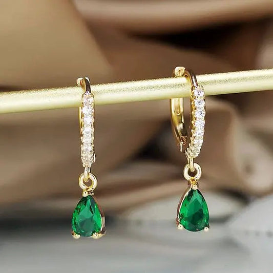 Earrings with dangling crystal in gold