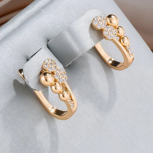 Elegant gold earrings with bright dots